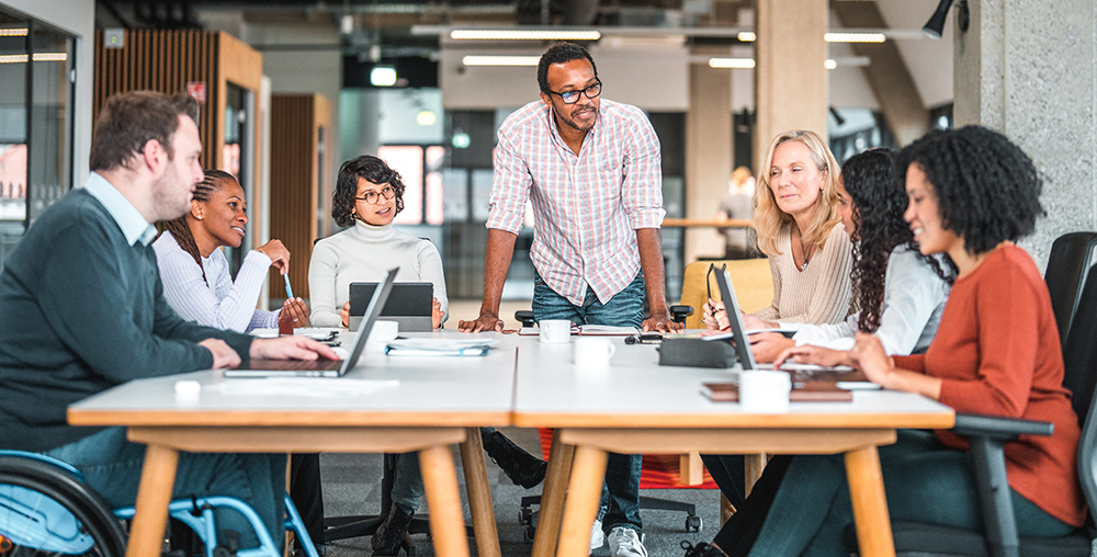 group of diverse coworkers sitting around a table at a meeting