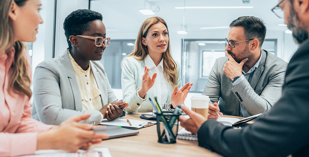 group of business people talking around a table