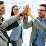 group of business people giving a high five