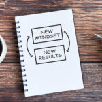 notebook with graphic that says new mindset and new results