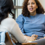 Two business women talking in a performance review