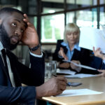 man in business meeting looking confused