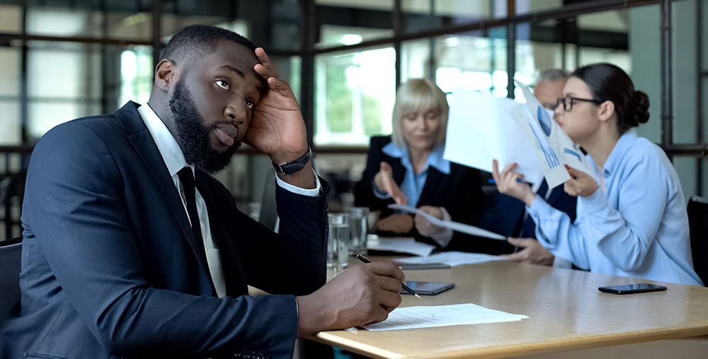 man in business meeting looking confused