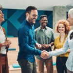 Smiling business persons shaking hands